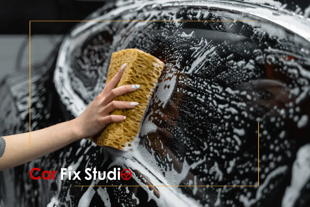Using sponge to clean a black car with PPF and ceramic coating-min